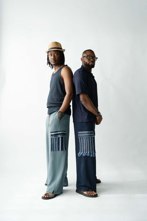 Luxury pale blue men's wide-leg trousers with artisan Aso Oke cargo pocket and premium textured fabric.