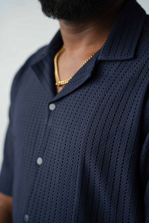 Premium textured knit fabric detail on men's midnight navy resort shirt