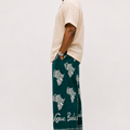 Side view of the baale vogue tie and die trouser in green adire