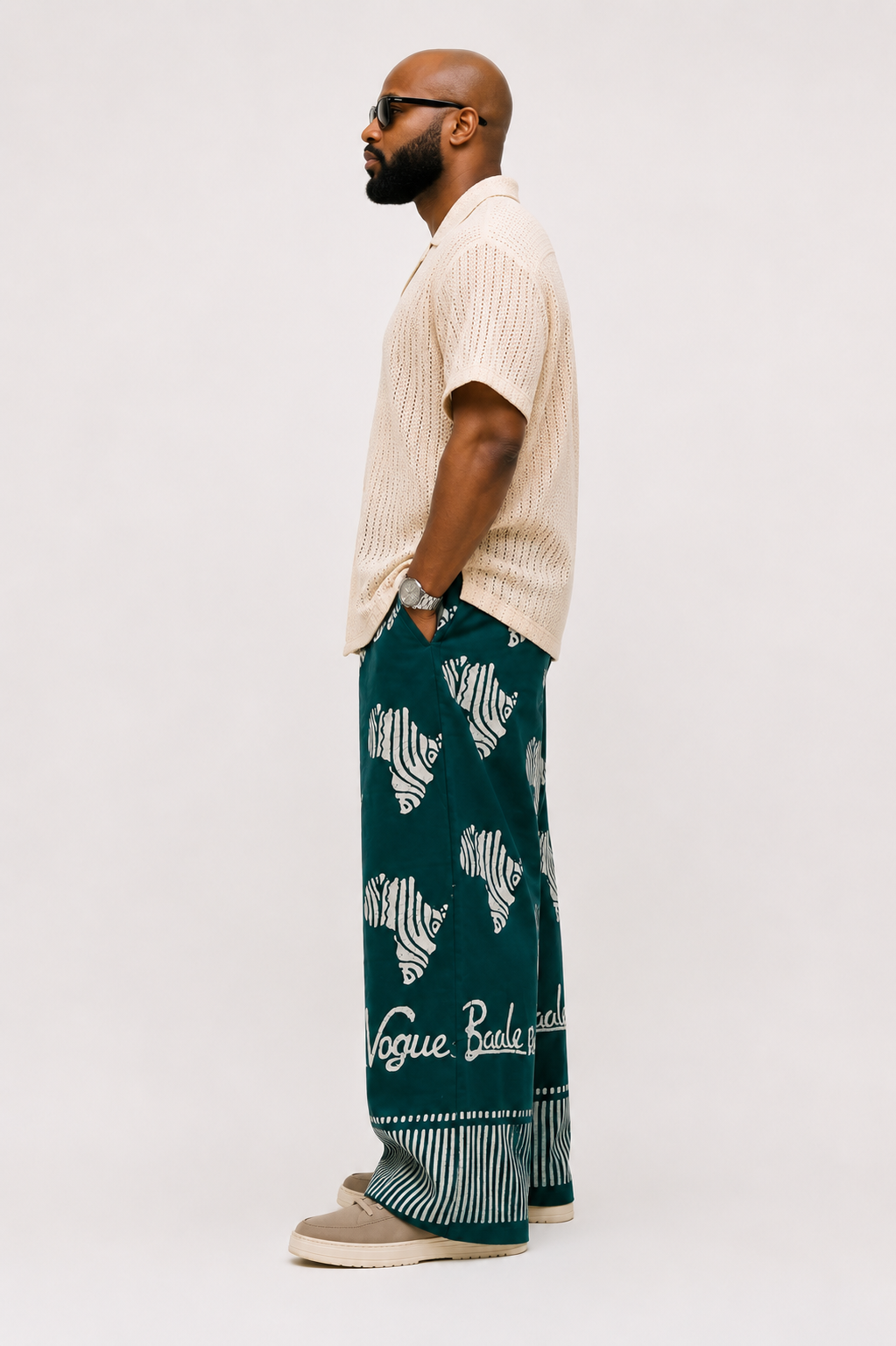 Side view of the baale vogue tie and die trouser in green adire