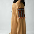 Luxury brown wide-leg cargo trousers for men featuring handcrafted Aso Oke pockets, premium textured fabric, drawstring waist and contemporary African-inspired design. This designer statement piece blends traditional craftsmanship with modern menswear styling.