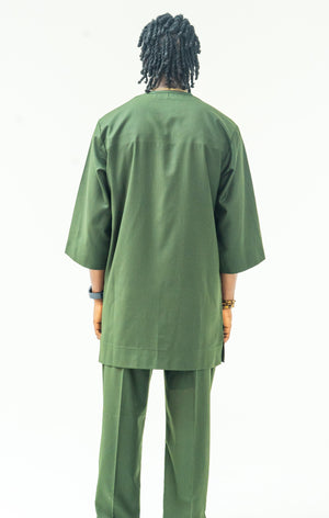 Person wearing a green outfit on a white background