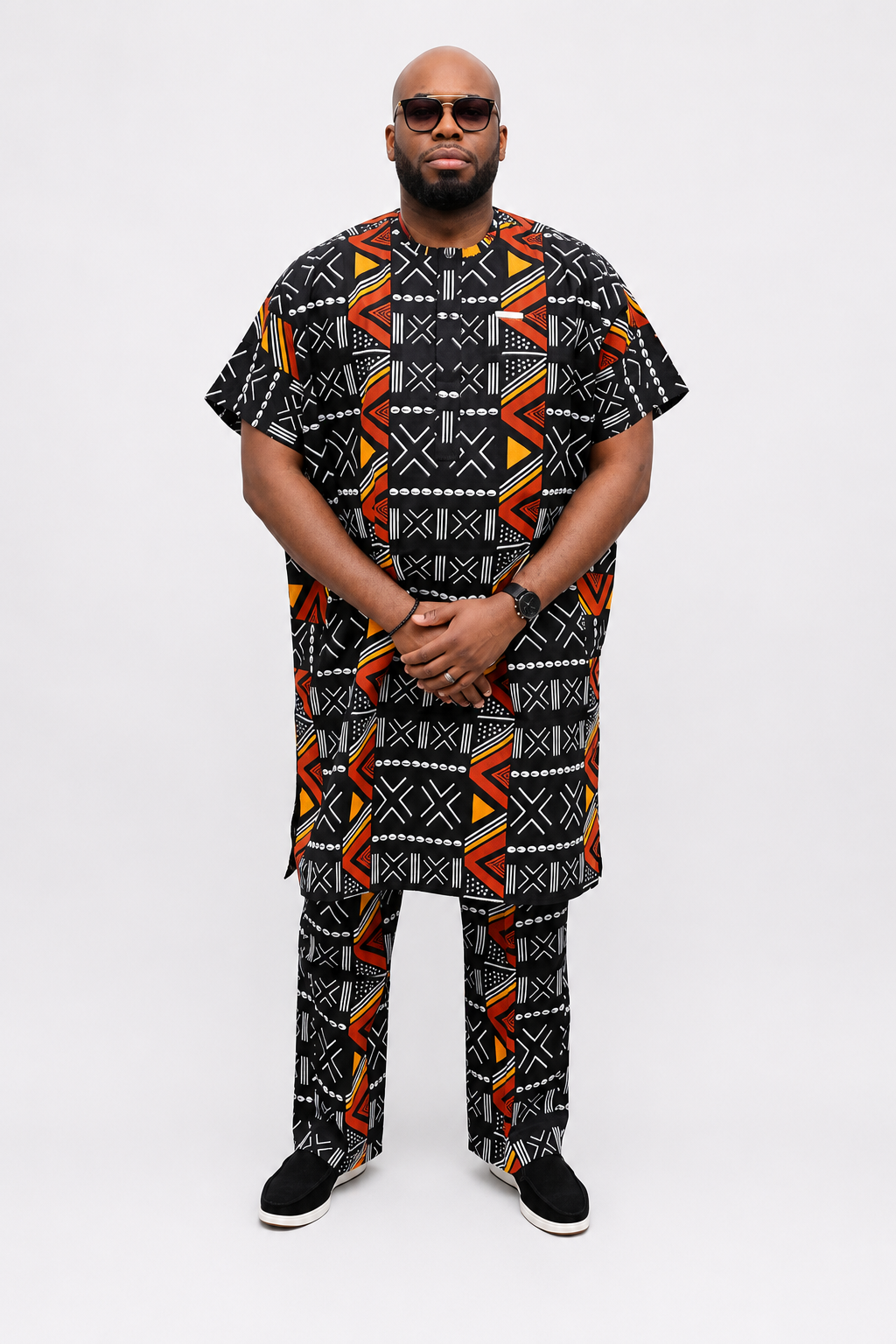 Three-quarter view of luxury black African print men's danshiki and trouser set by Baale Vogue, showcasing premium tailoring and geometric Ankara design.