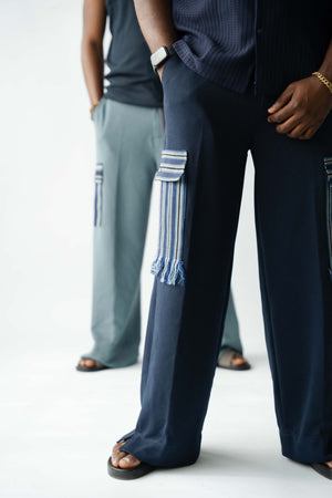 Premium African luxury wide-leg cargo trousers in navy blue featuring statement Aso Oke pocket and contemporary styling