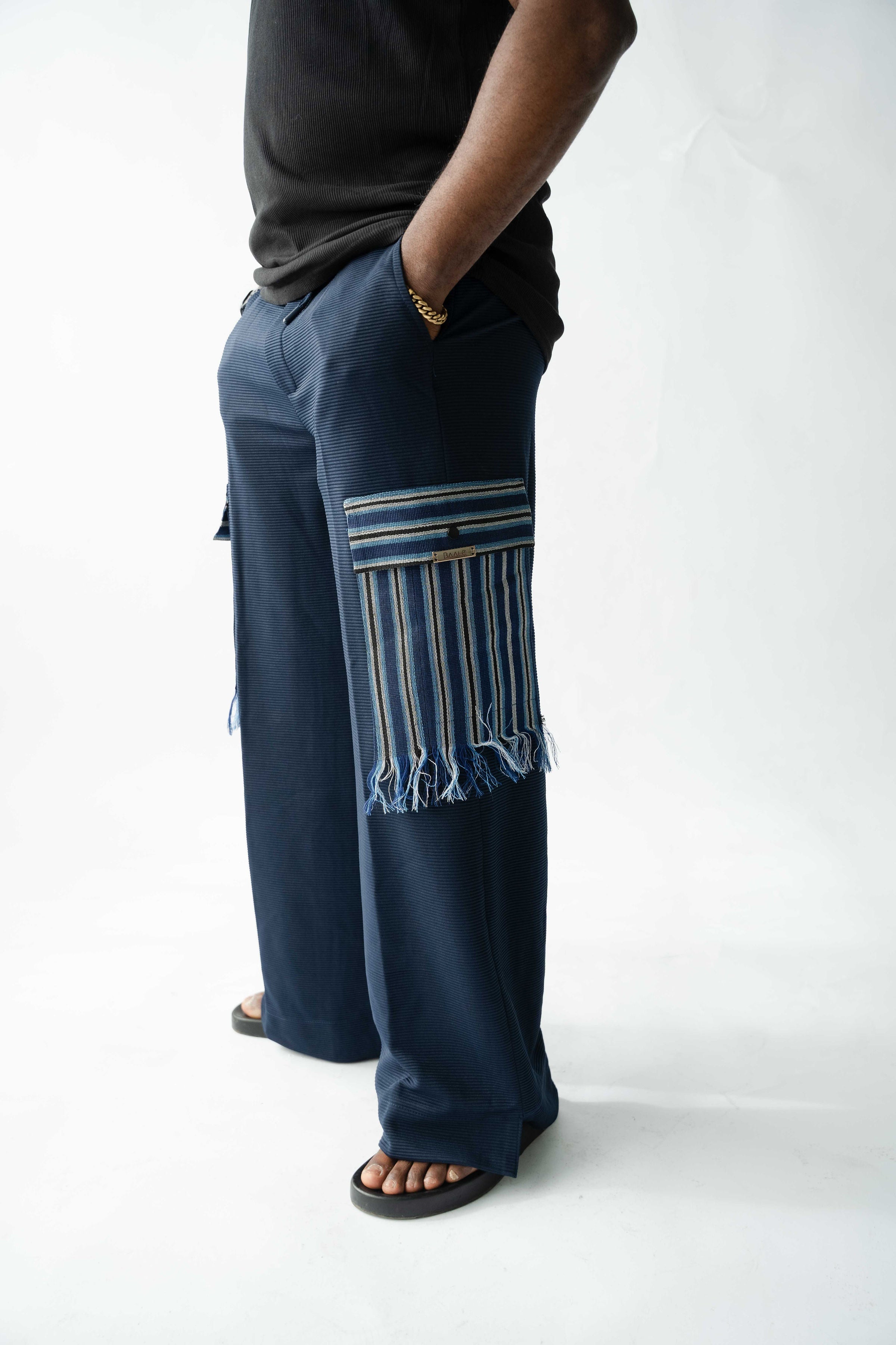 Luxury navy wide-leg cargo trousers for men featuring striped Aso Oke cargo pocket and premium textured fabric.