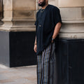 Balogun Aso Oke Set featuring a black tunic and striped Aso Oke trousers