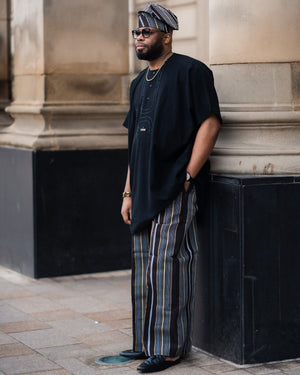 Balogun Aso Oke Set featuring a black tunic and striped Aso Oke trousers