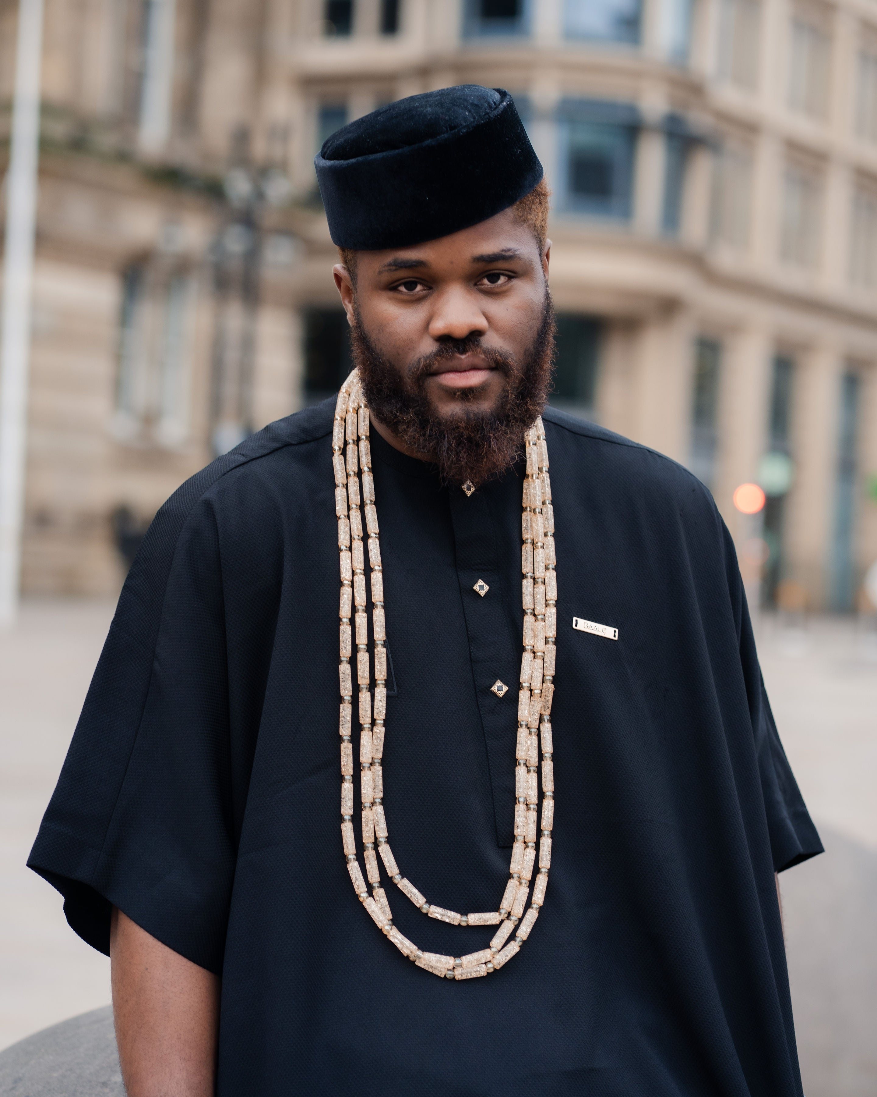 Traditional African men's black kaftan outfit with matching trousers