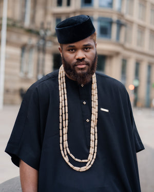 Traditional African men's black kaftan outfit with matching trousers