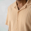 Close-up detail of textured knit fabric on men's resort shirt